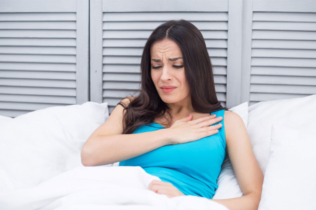 Woman noticing upper-body discomfort